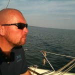 On the helm.
