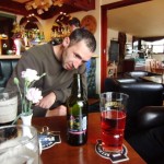 Peter inspects the pink cider that they drink in Scotland.